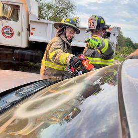 Probationary FF Leonard is seen here learning how to cut out the front windshield using a powered cutting tool